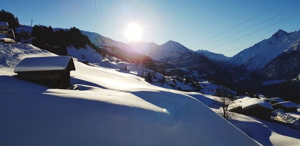 Snow covered mountains against sky on sunny day