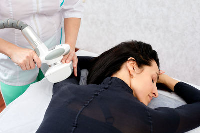 Side view of young woman using mobile phone