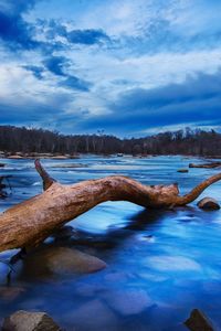 Scenic view of lake against sky during winter