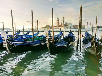 Gondolas moored on grand canal in city