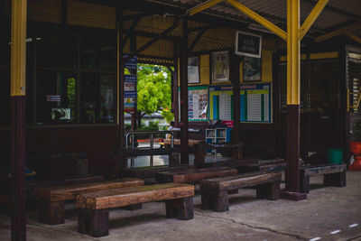 Empty chairs and tables in illuminated building