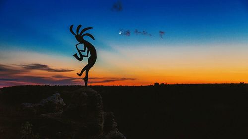 Silhouette of landscape against sky at sunset