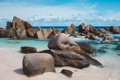 Rocks on beach against sky