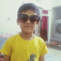 Portrait of boy wearing sunglasses standing outdoors