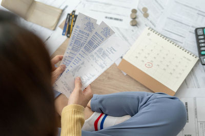High angle view of people sitting on table