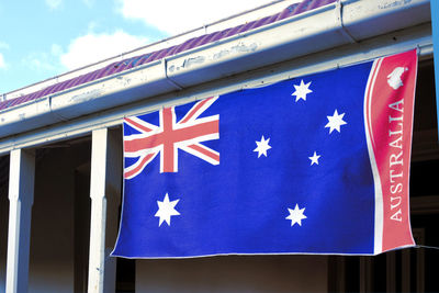 Low angle view of flag against blue sky