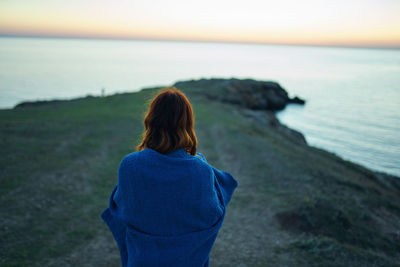 Rear view of woman looking at sea shore