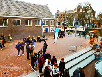 High angle view of people walking on street in city