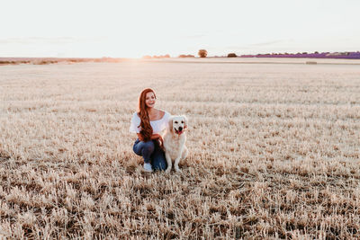 Woman with dog on field