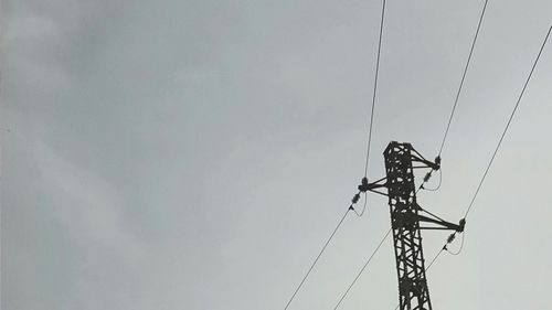 Low angle view of telephone pole against sky