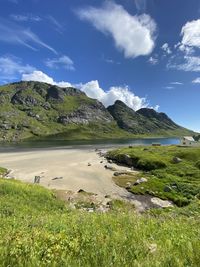 Scenic view of beach landscape against sky and mountain