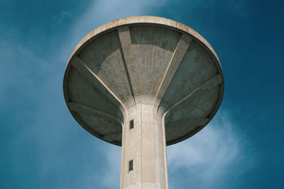 Tower of the aqueduct against blue sky, brutalist architecture