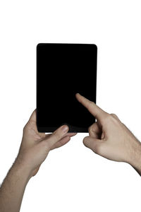 Low section of person using smart phone against white background