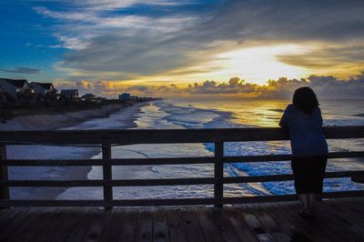 Rear view of man looking at sea