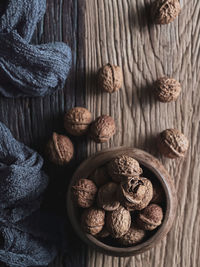 Walnut in a wooden bowl and on the wooden table