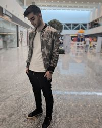 Young man standing on floor in city