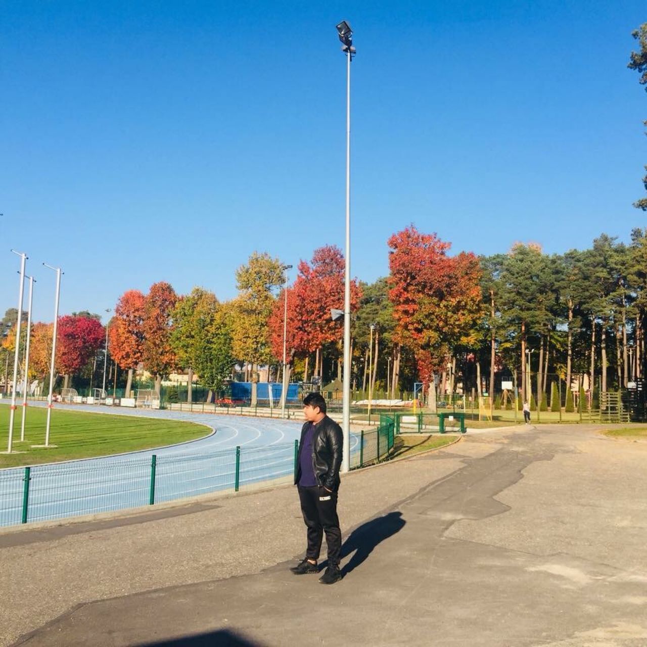 MAN WALKING ON FOOTPATH AGAINST SKY