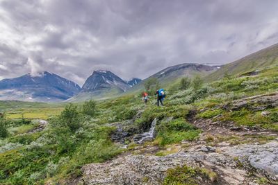 Scenic view of mountains against cloudy sky