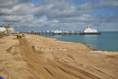 Construction vehicle carrying out coastal defence and beach replenishment. eastbourne, east sussex. 