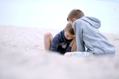 Rear view of couple kissing on beach