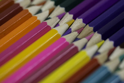 Full frame shot of colored pencils arranged on table