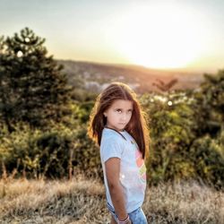 Portrait of a girl standing on field