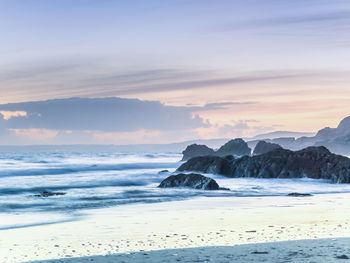 Scenic view of beach against sky during sunset