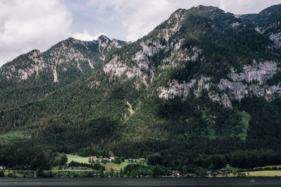 Scenic view of river amidst trees against mountains