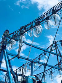 Low angle view of ferris wheel against blue sky