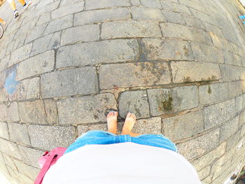 Low section of woman standing on tiled floor