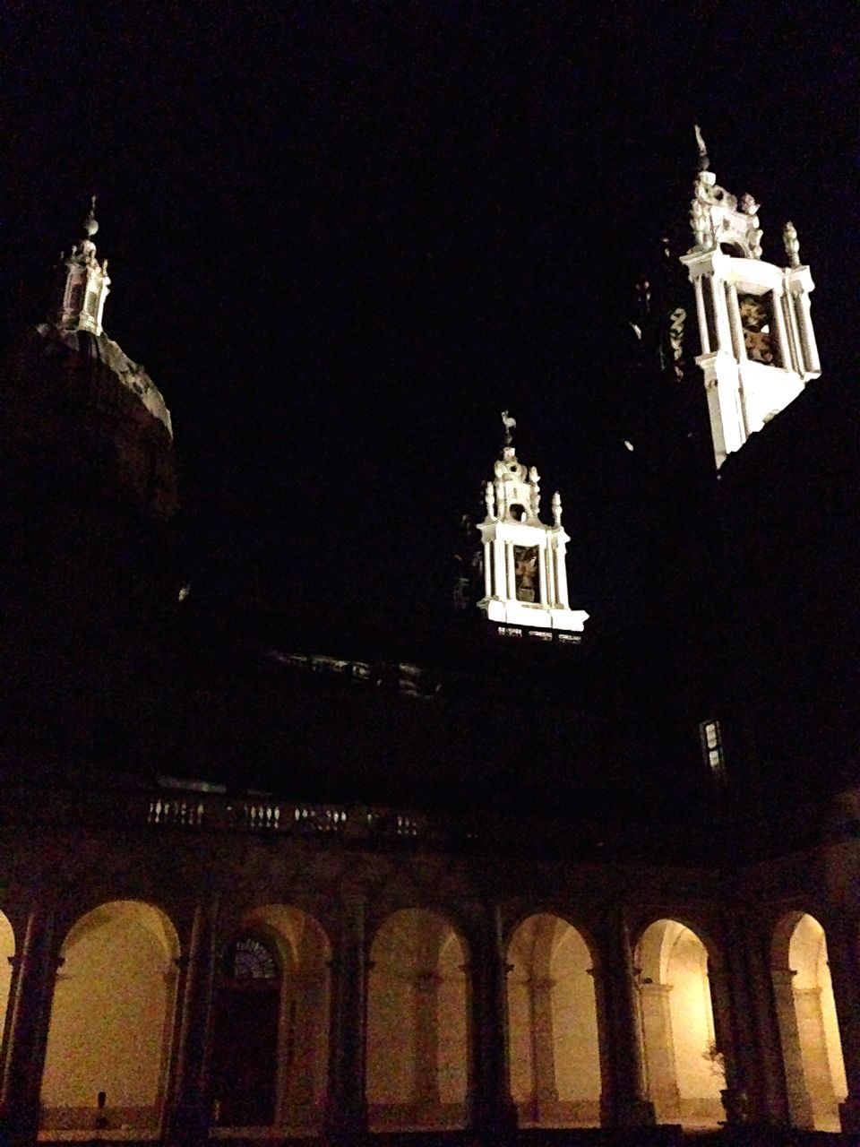 religion, architecture, building exterior, church, place of worship, built structure, spirituality, low angle view, night, cross, cathedral, clear sky, facade, high section, illuminated, copy space, window, sky