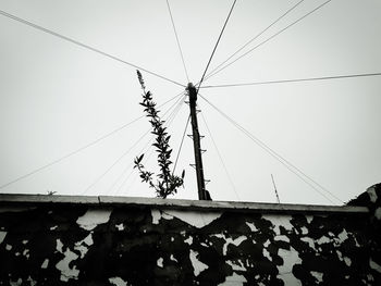 Low angle view of electricity pylon against sky