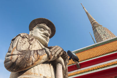 Low angle view of statue against building