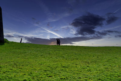Man standing on field against sky