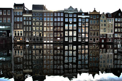 Row of buildings with reflection on canal