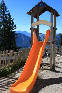 Wooden post in playground against sky