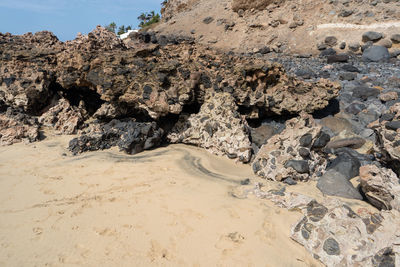 Rocks on beach against sky