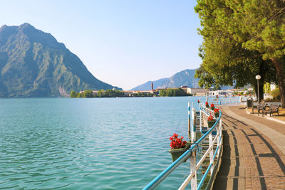 Scenic view of lake and mountains against clear sky