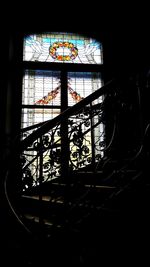 Silhouette building seen through glass window