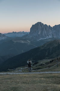 Man standing on mountain against sky