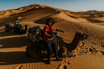 Man on sand dune in desert