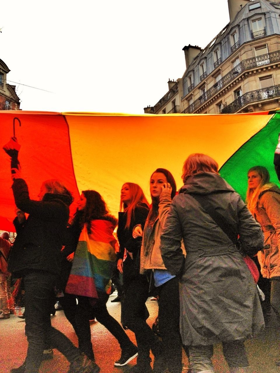 architecture, building exterior, lifestyles, built structure, men, casual clothing, leisure activity, clear sky, person, togetherness, standing, city, bonding, rear view, full length, walking, large group of people, outdoors