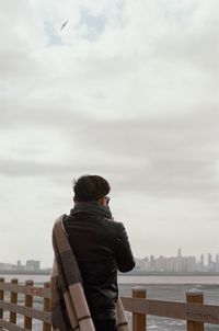 Rear view of man looking at cityscape