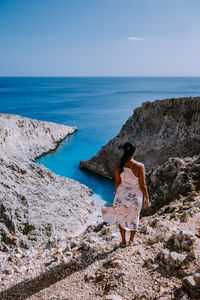 Rear view of woman looking at sea shore