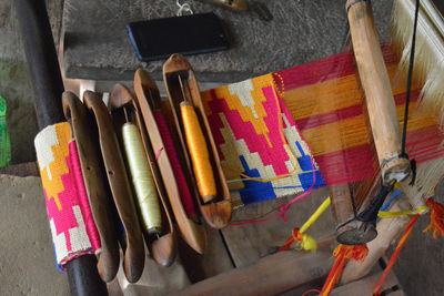 High angle view of multi colored spools on table