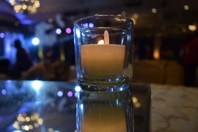 Close-up of tea light candle on table at restaurant