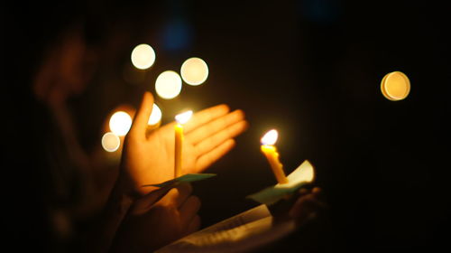 Close-up of lit candles in the dark