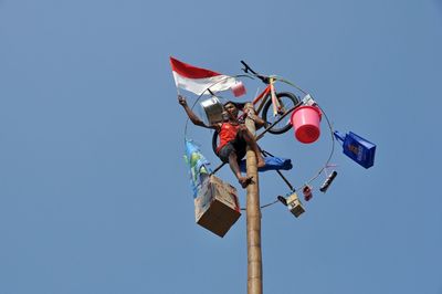 Low angle view of colorful balloons against clear blue sky