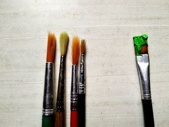Directly above shot of paintbrushes on table