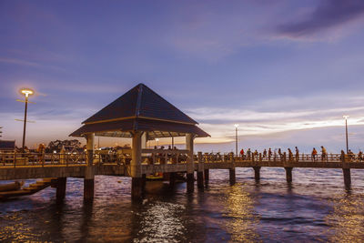 Reflection of built structure in water at sunset